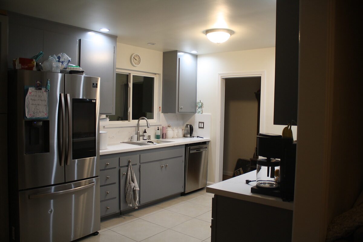 Kitchen before remodel — grey cabinets, dated layout